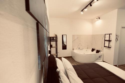 a bathroom with a bath tub and a large white bath tub at Elene Suites Soggiorno Mediterraneo in Palermo