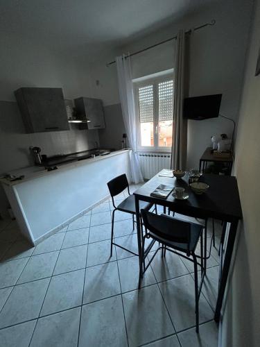 a kitchen with a table and chairs in a room at My Suite Fiuggi in Fiuggi