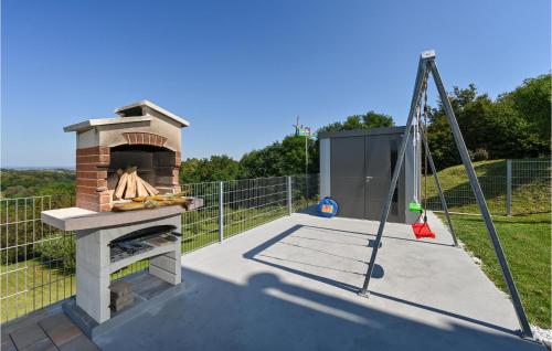a outdoor oven with a tray of food on a patio at Awesome Home In Radovan With Sauna in Lovrečan Podbelski