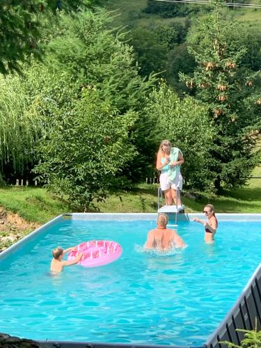 a group of people in a swimming pool at Perlyna Krasiyi in Vyshka