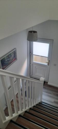 a stairway with a white railing and a window at Lanarkshire Apartment- Views- Sleeps 4- Balcony in Larkhall