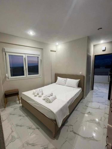a bedroom with a bed with towels on it at Villa Athina 2 in Serres