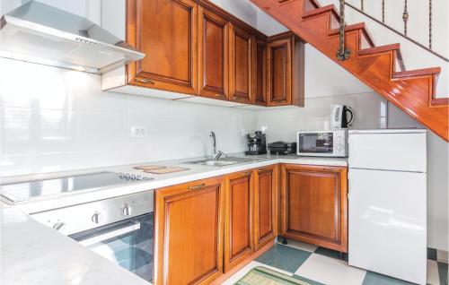 a kitchen with white appliances and wooden cabinets at Apartment Gracisce 07 in Gržići