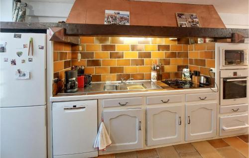 a kitchen with a white refrigerator and a sink at 7 Bedroom Awesome Home In Charlieu in Charlieu