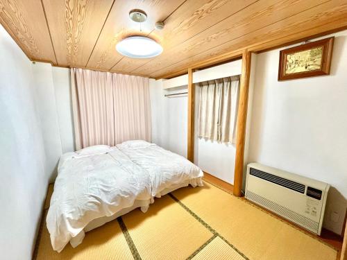 Katil atau katil-katil dalam bilik di 戸狩野沢スノーパークプラザSnow Park Plaza
