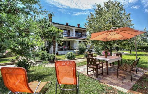 a patio with a table and chairs and an umbrella at Apartment Mugeba I in Poreč