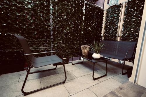 a chair and a table on a balcony with a wall at Elene Suites Soggiorno Mediterraneo in Palermo