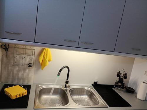 a kitchen sink with a faucet and a counter top at Irini in Thérissos