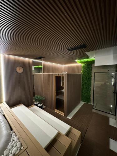 a living room with a couch and a green wall at Gencian resort in Kopaonik