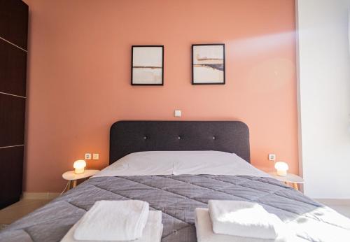 a bedroom with a bed with three pictures on the wall at Ξενώνας Βυσωκά in Kalavrita