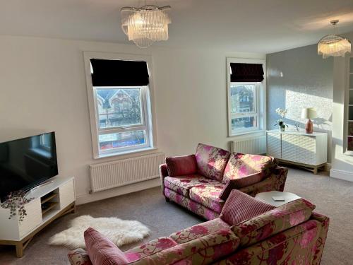 a living room with a couch and a tv at The Place - Lytham in Lytham St Annes