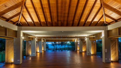 a large room with a wooden ceiling and a wooden floor at Siddhalepa Ayurveda Resort - All Meals, Ayurveda Treatment and Yoga in Wadduwa