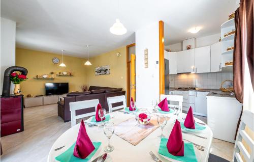 a kitchen and a living room with a table and chairs at Gorgeous Home In Zaton Veliki in Zaton