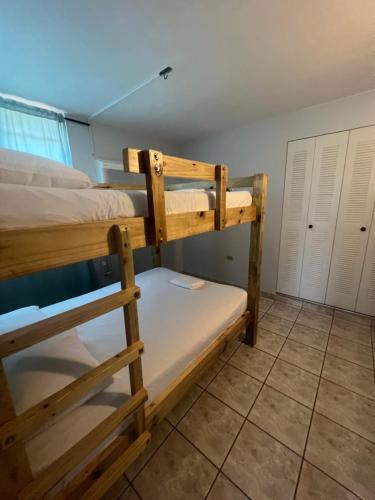 a bedroom with two bunk beds in a room at Boquerón Beach & Country Cabins in Boqueron