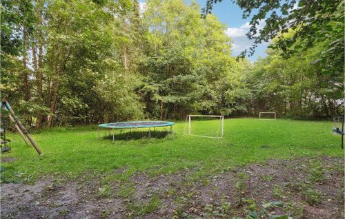 a trampoline in the middle of a field with trees at 7 Bedroom Stunning Home In Sønder Omme in Sønder Omme