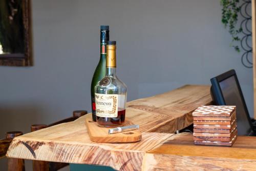a bottle of wine sitting on top of a wooden table at The Cacoon Tsitsikamma in Stormsriviermond