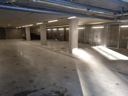 an empty parking garage with columns and lights at Apartman terasa v Dole in Cerny Dul