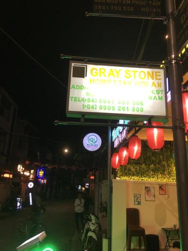 a sign for a gym store at night at Gray Stone homestay in Hoi An