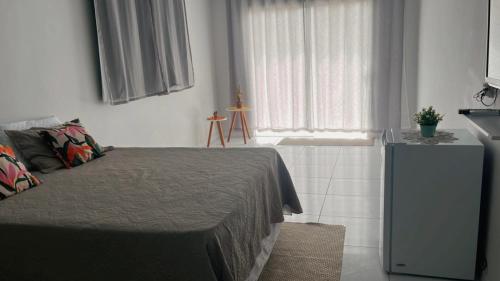 a bedroom with a bed and a window at Chalé da Barra in Tutóia