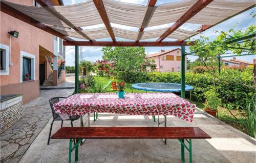 a table and chairs under a pergola on a patio at 1 Bedroom Stunning Apartment In Kastel in Kaštel