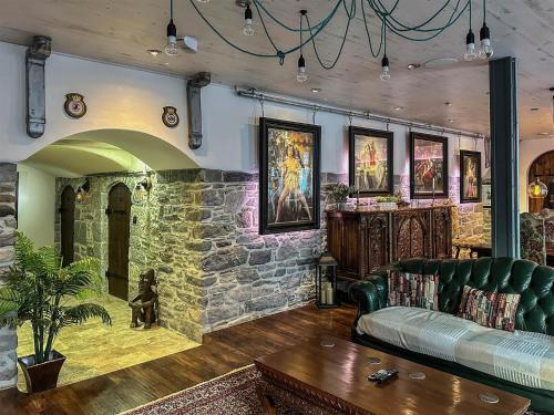 a living room with a couch and a stone wall at The Catacombs-Barbican - Pet Friendly - 5 Guests in Plymouth