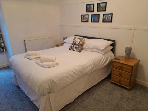 a bedroom with a bed with towels on it at Cottage in Wells in Wells