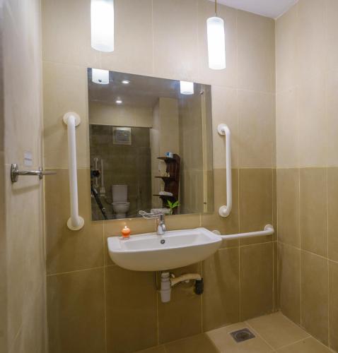 a bathroom with a sink and a mirror at Siddhalepa Ayurveda Resort - All Meals, Ayurveda Treatment and Yoga in Wadduwa