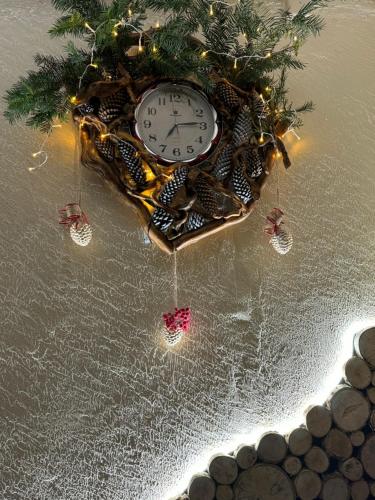 a clock with christmas decorations on top of the snow at Perlyna Krasiyi in Vyshka