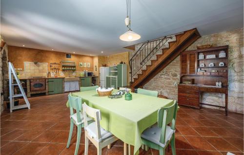 a kitchen and dining room with a table and chairs at Holiday Home Butkovici Croatia in Butkovići