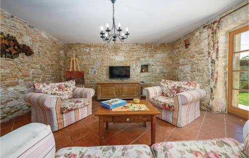 a living room with two chairs and a table at Holiday Home Butkovici Croatia in Butkovići