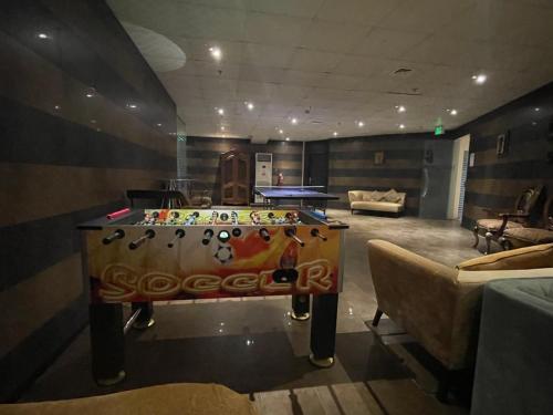 a room with a pool table in the middle of it at Wakra Inn Hotel Apartments in Al Wakrah