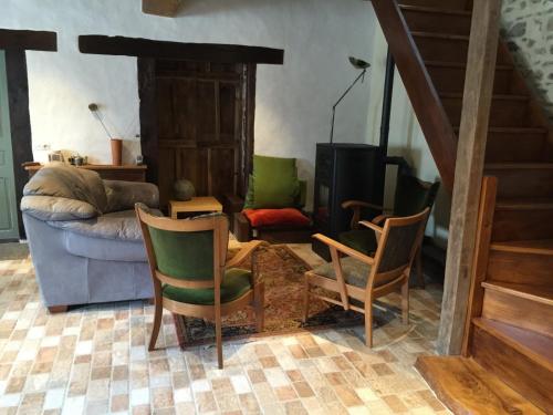 a living room with chairs and a couch at Les Bouis in Saint-Hilaire