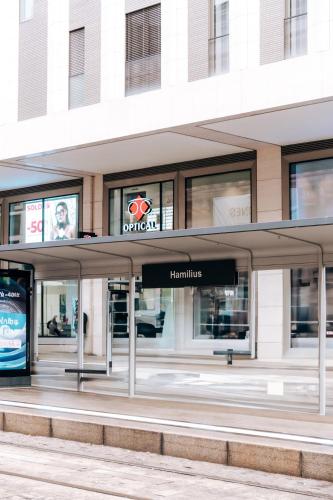 a building with a sign for a store at Luxe City - Modern & Spacious 2BR with Balcony View in Luxembourg