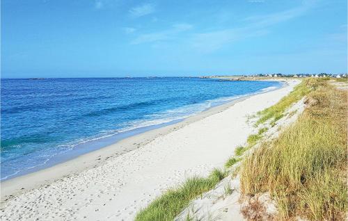 une plage de sable au bord de l'océan par une journée ensoleillée dans l'établissement Lovely Home In Guisseny, à Guissény