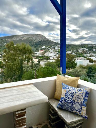 a bench sitting on a balcony with a view at Jasmine of Cyclades in Kinion