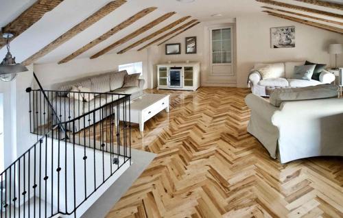 a living room with white furniture and wooden floors at Beautiful Home In Novi Vinodolski in Novi Vinodolski