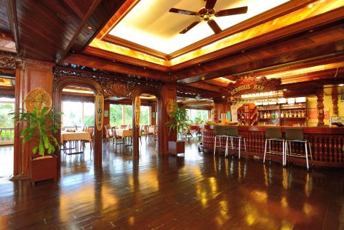 a large room with a bar in a restaurant at Airai Water Paradise Hotel & Spa in Koror