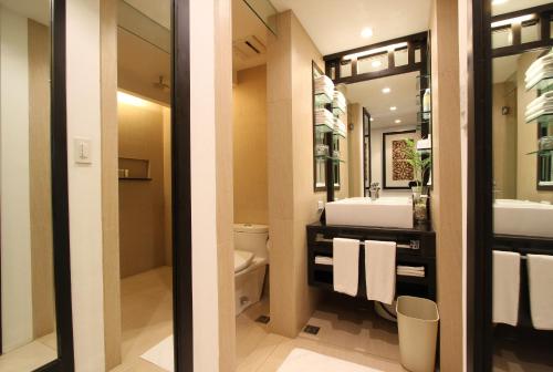 a bathroom with a toilet and a sink at The District Boracay in Boracay