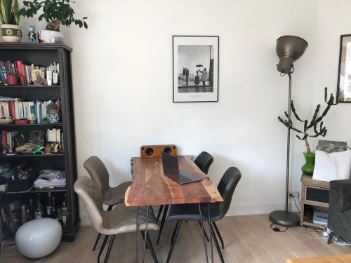 a dining room with a wooden table and chairs at Beautiful quiet Apt in the center of Amsterdam in Amsterdam