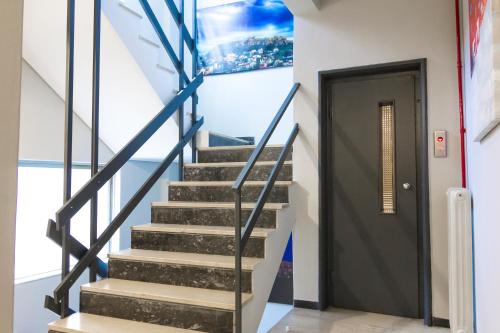 a stairway with a black door in a building at Zappion Hotel in Athens