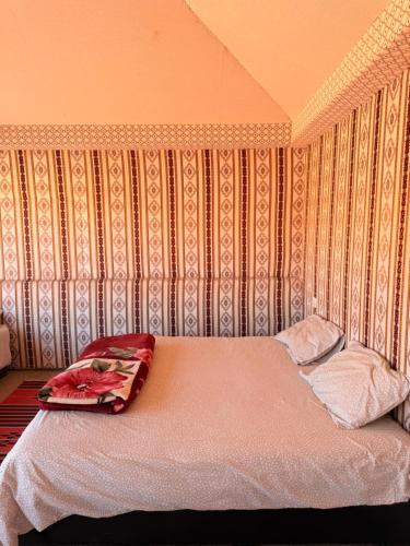 a bed in a room with a wall at Milky Way Wadi Rum in Wadi Rum