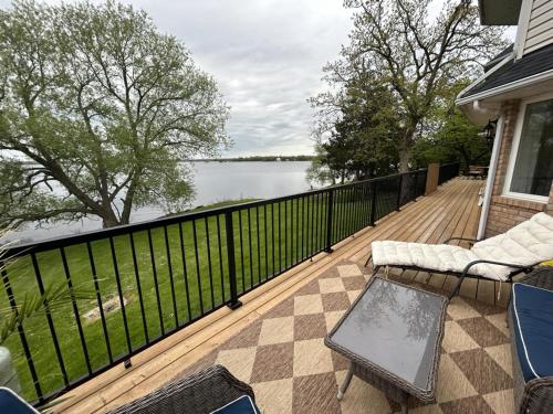 a deck with a view of the water on a house at Romantic Waterfront Sunset Views in PEC in Belleville