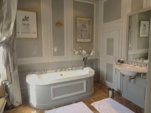 a bathroom with a large tub and a sink at Château de Saint Trys in Anse