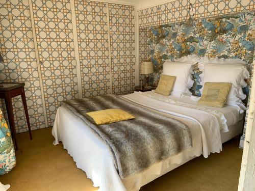 a bedroom with a large white bed in a room at Château de Saint Trys in Anse