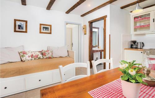 a small room with a bed and a table at Nice Home In Cres With Wifi in Cres