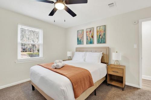 Un dormitorio con una cama y un ventilador de techo. en Kings Way Bungalow, en Savannah