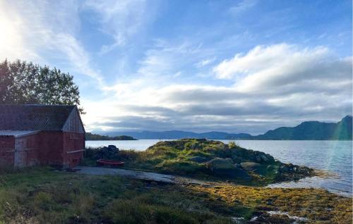 an old building on the shore of a body of water at Gorgeous Home In Øydegard With Wifi in Aspa
