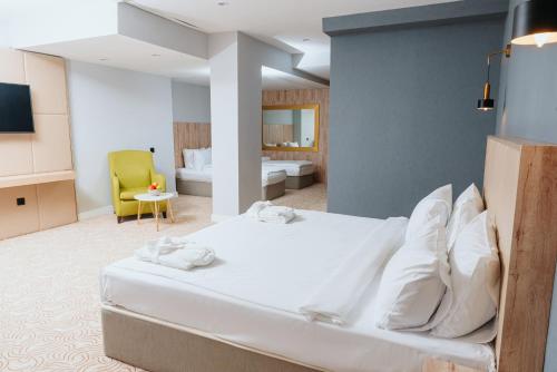 a bedroom with a large white bed in a room at CONGRESS Hotel in Baku