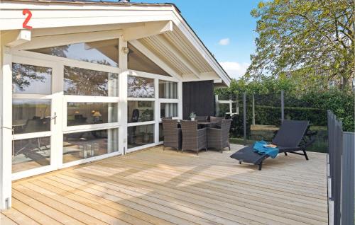 a screened in deck with a patio furniture on it at Holiday Home Grønningen Børkop Denm in Egeskov