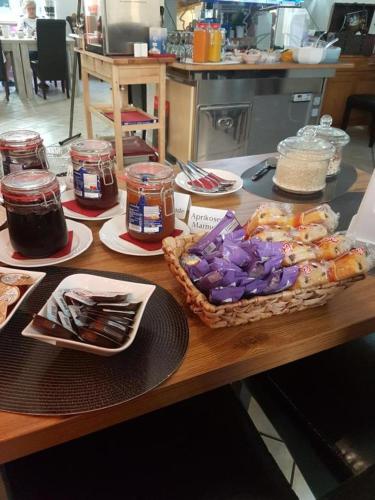 a table with food and jars of jam on it at Hotel Schweizer Stubb in Kaiserslautern